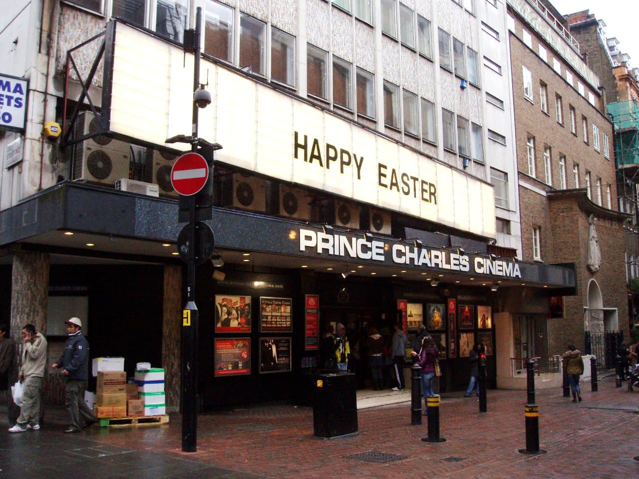 Prince Charles Cinema frontage on a wet London street, with a Happy Easter sign above the entrance